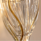 Close-up of a decorative wall light fixture with gold and clear glass design.
